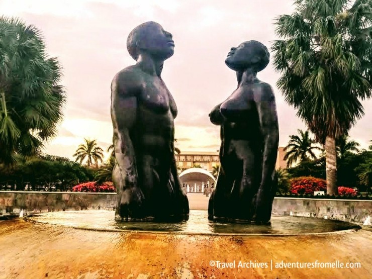 Statue of a man and woman standing in a fountain