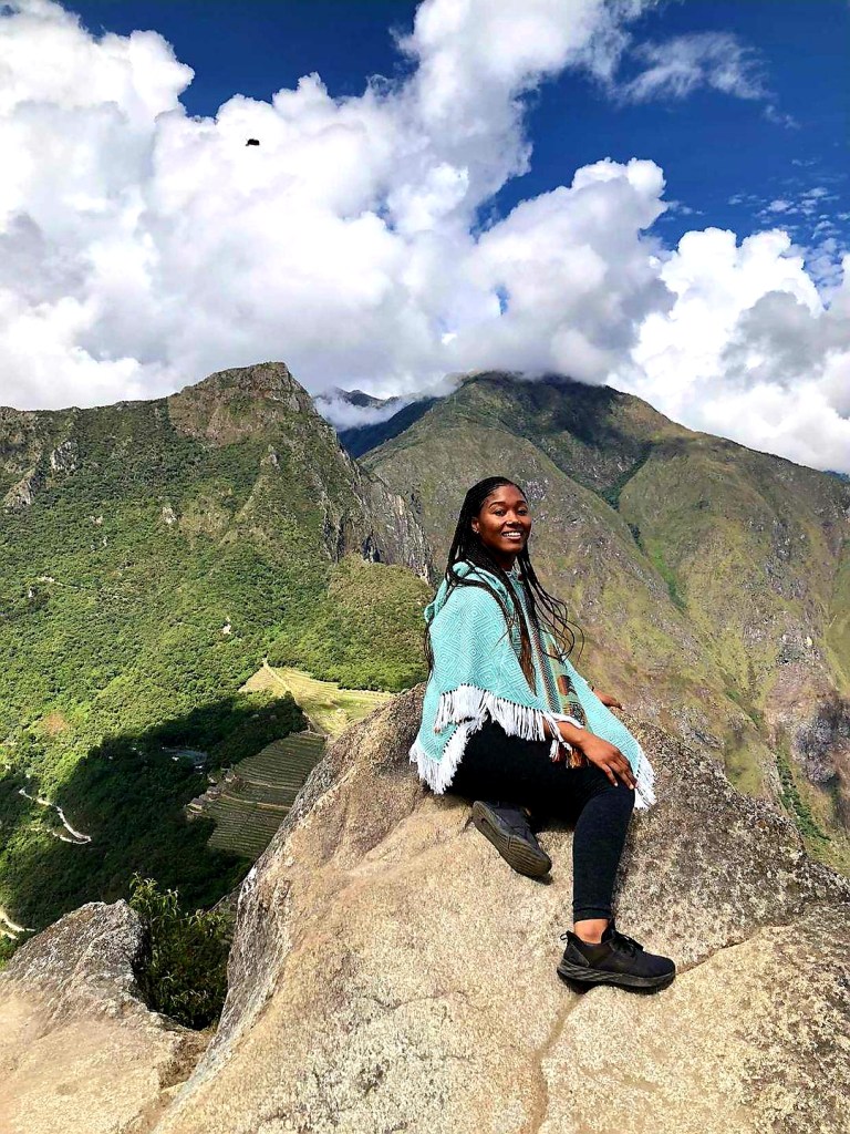 Girl sits on rock at Huayna Picchu