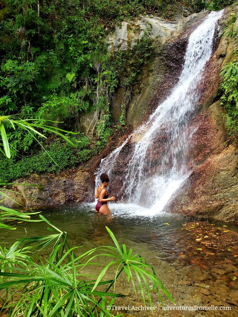 Girl standing close to waterfall