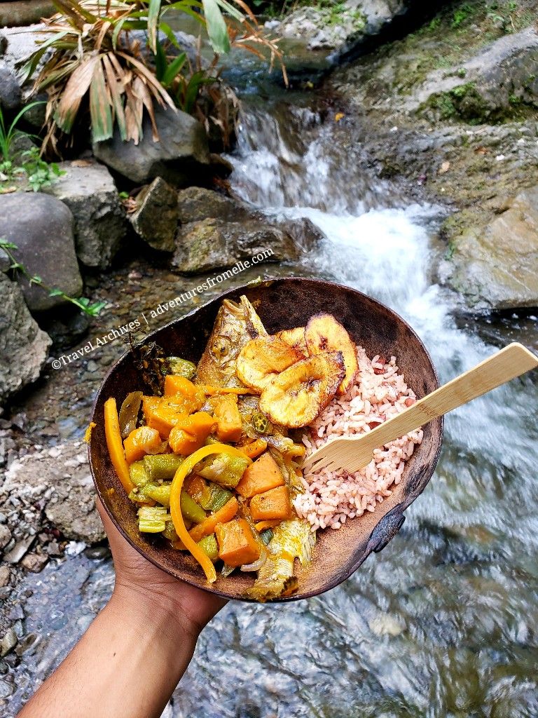 Bowl of rice, plantain, fish and vegetables