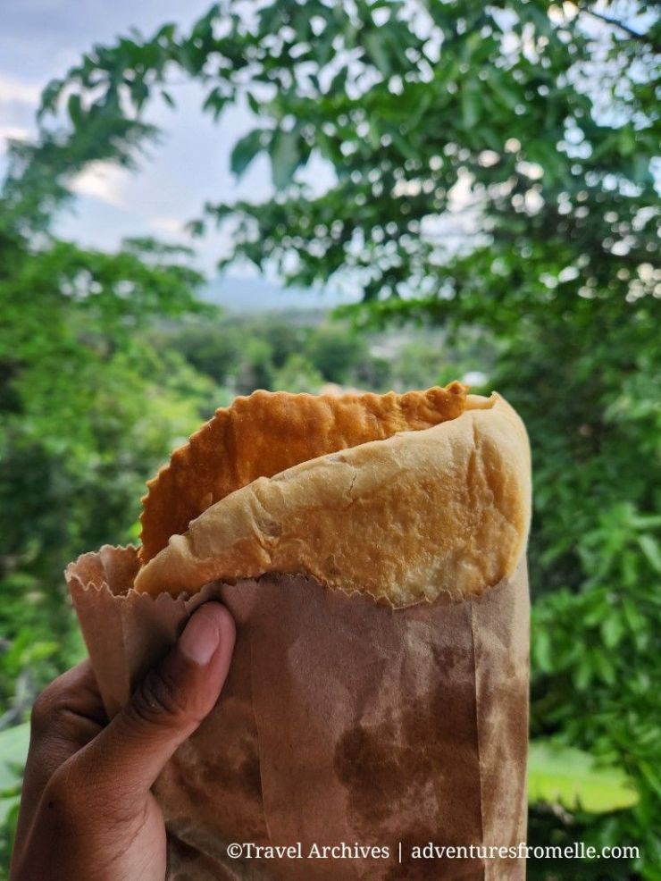 Patty and coco bread with forest backdrop